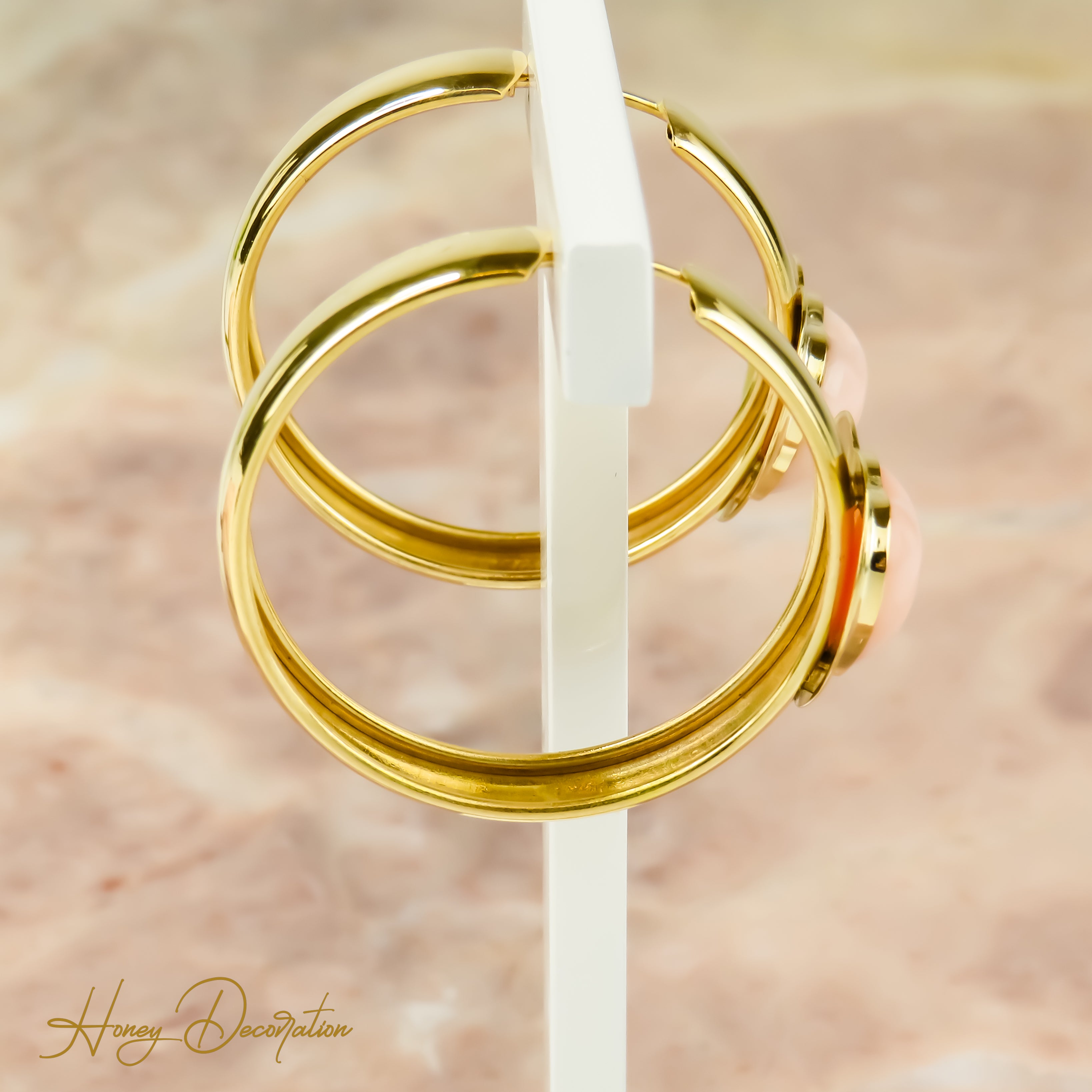 Striking creoles made of 18 karat gold with coral insert