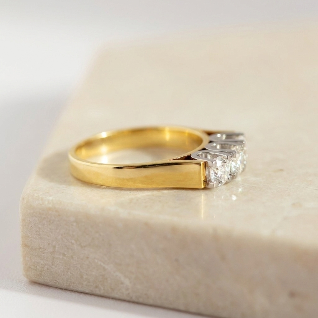 Thick flat-top yellow gold band with three white gold set diamonds