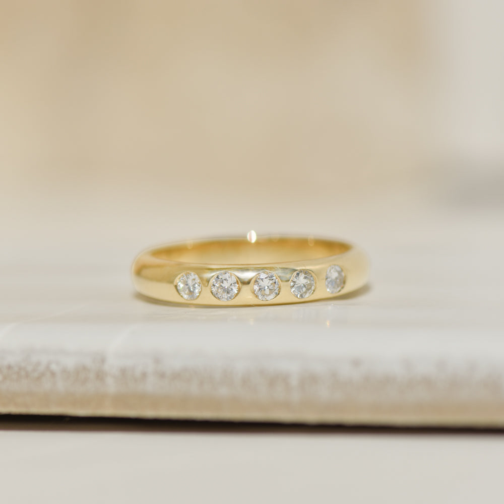 Ring made of 14K yellow gold with 5 inlaid diamonds – simple, elegant, forever good