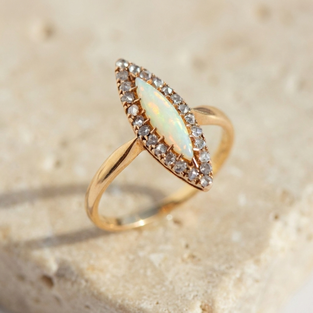 Top-down view of slender antique gold ring with central opal