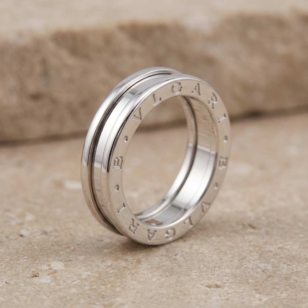 Side profile of polished Bulgari B Zero 1 white gold ring with engraved lettering