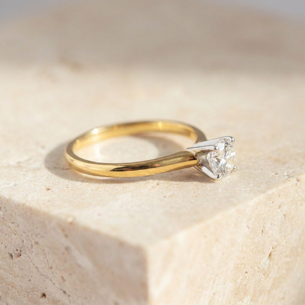 Close-up of 14k yellow gold band with four-prong white gold diamond setting