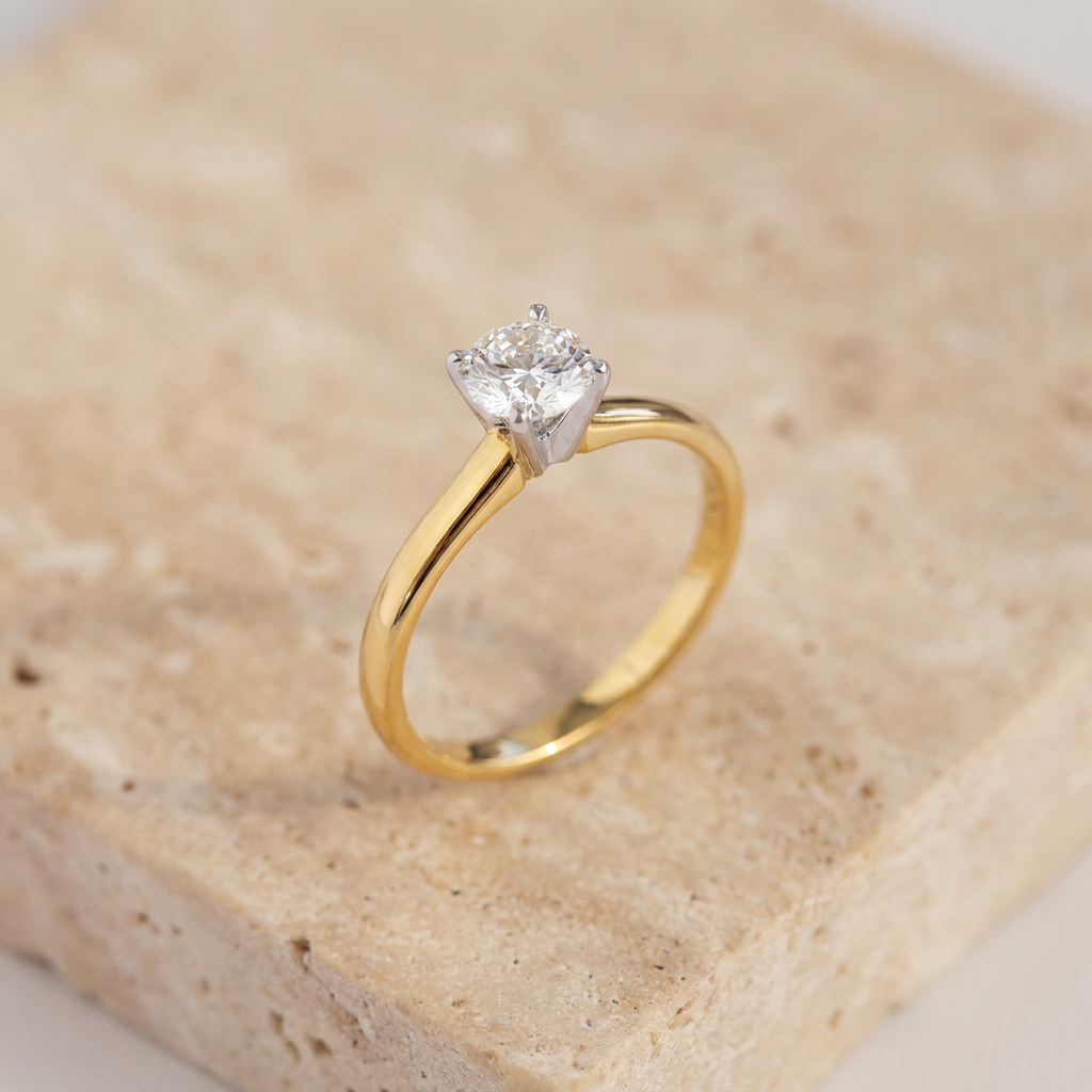 Front view of round brilliant cut diamond in two-tone yellow and white gold solitaire