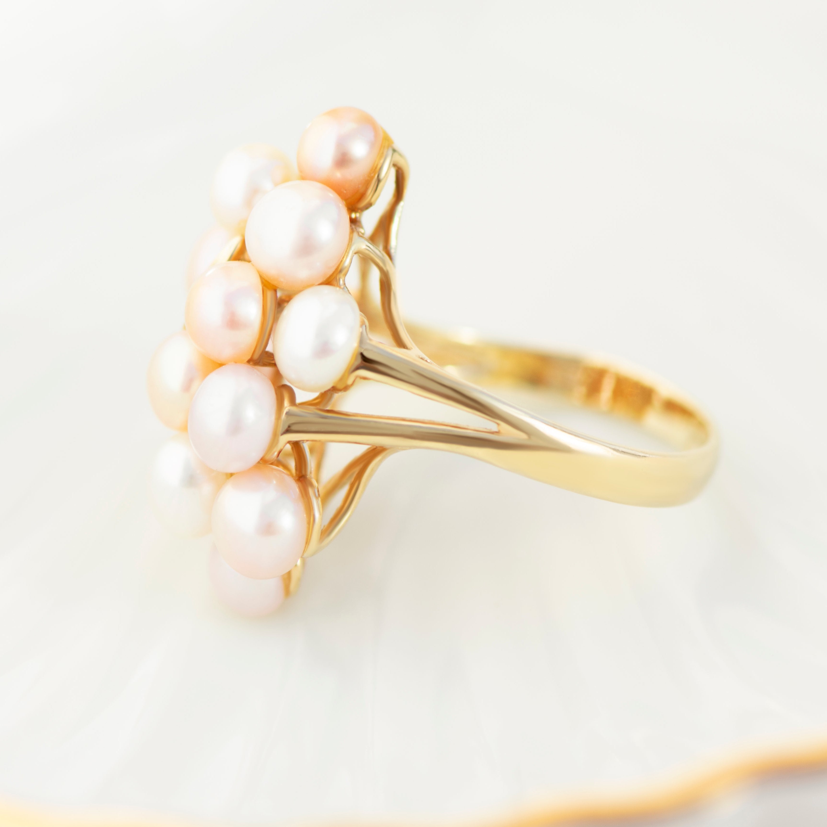 Split-shank 14k gold ring featuring rose cream and white pearl cluster with diamond vine