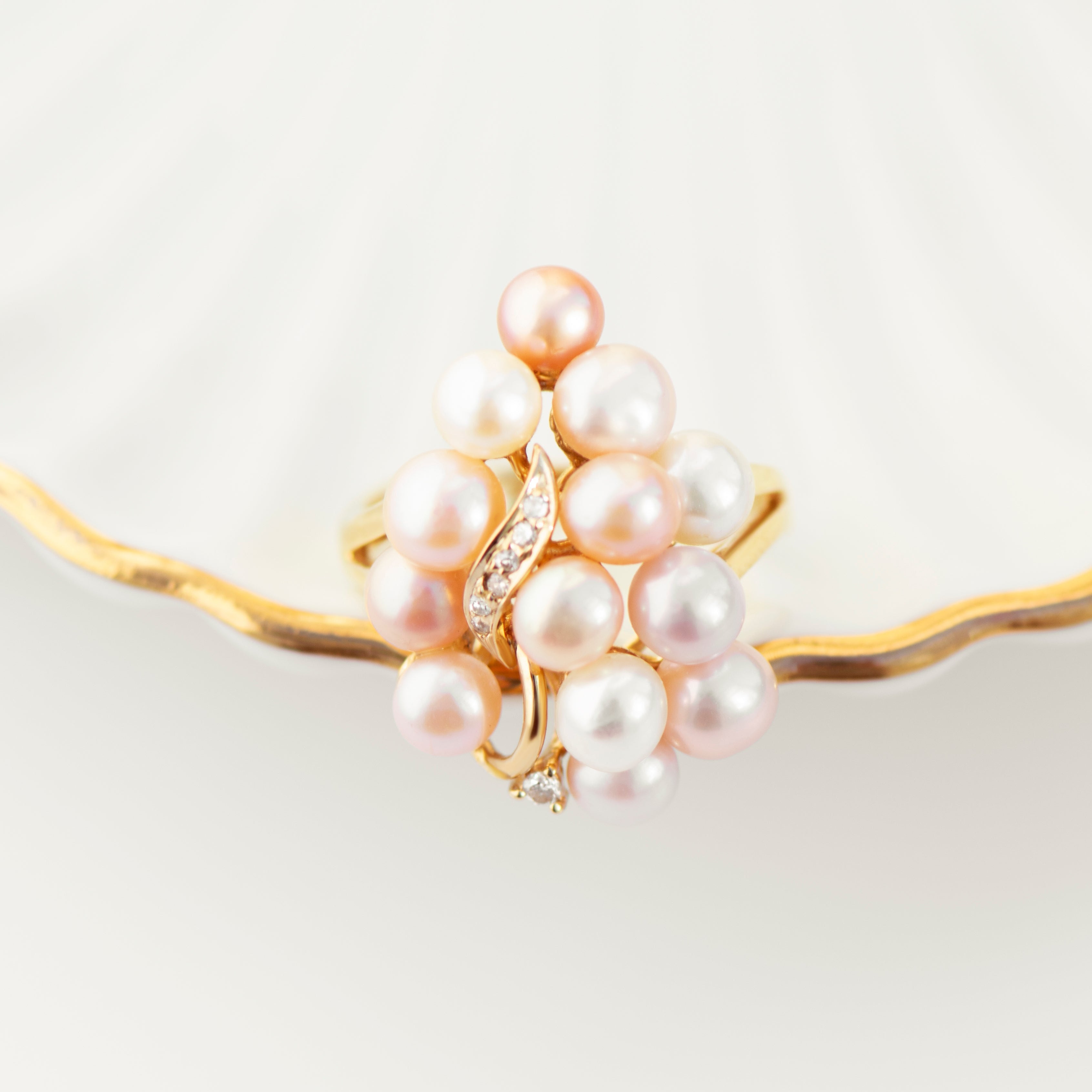 Dense 14k yellow gold ring with mixed tone pearls and diamond-studded leaf motif