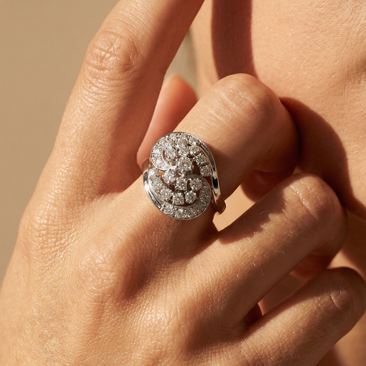 Vintage white gold ring with clustered brilliant diamonds on hand