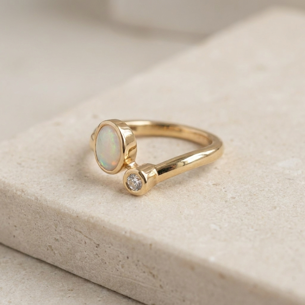 Minimalist 585 yellow gold Toi-et-Moi ring showcasing opal iridescence and diamond accent