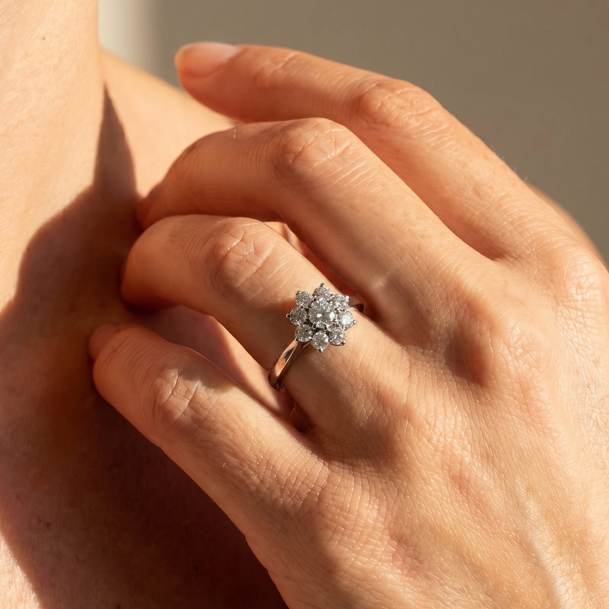 Vintage 750 white gold diamond ring with floral cluster setting and solitaire center stone